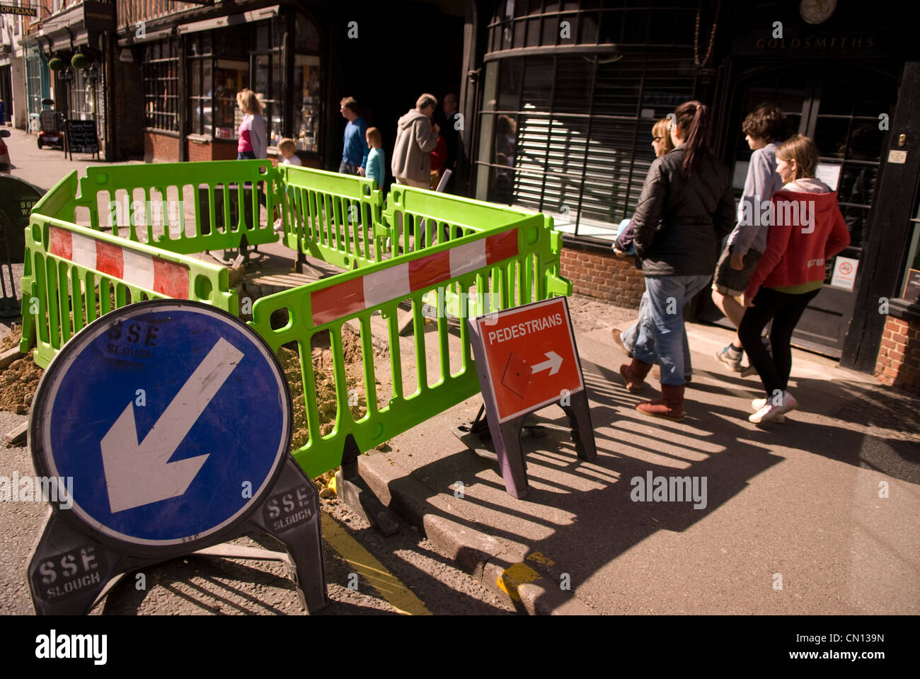 Pedestrians walking around roadworks, Farnham, Surrey, UK Stock Photo