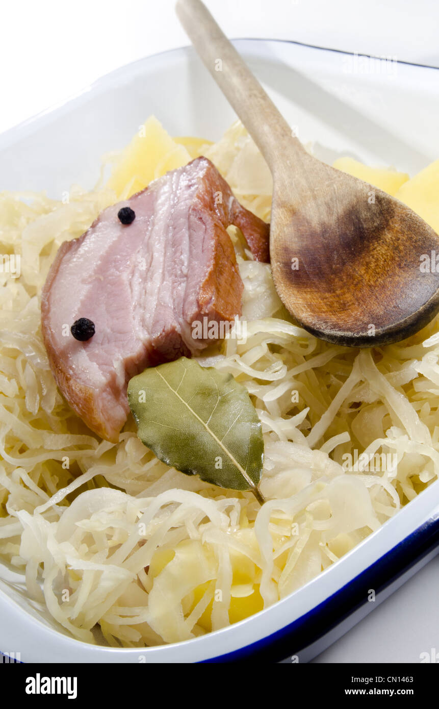 Steamed sauerkraut with pork and boiled potatoes Stock Photo