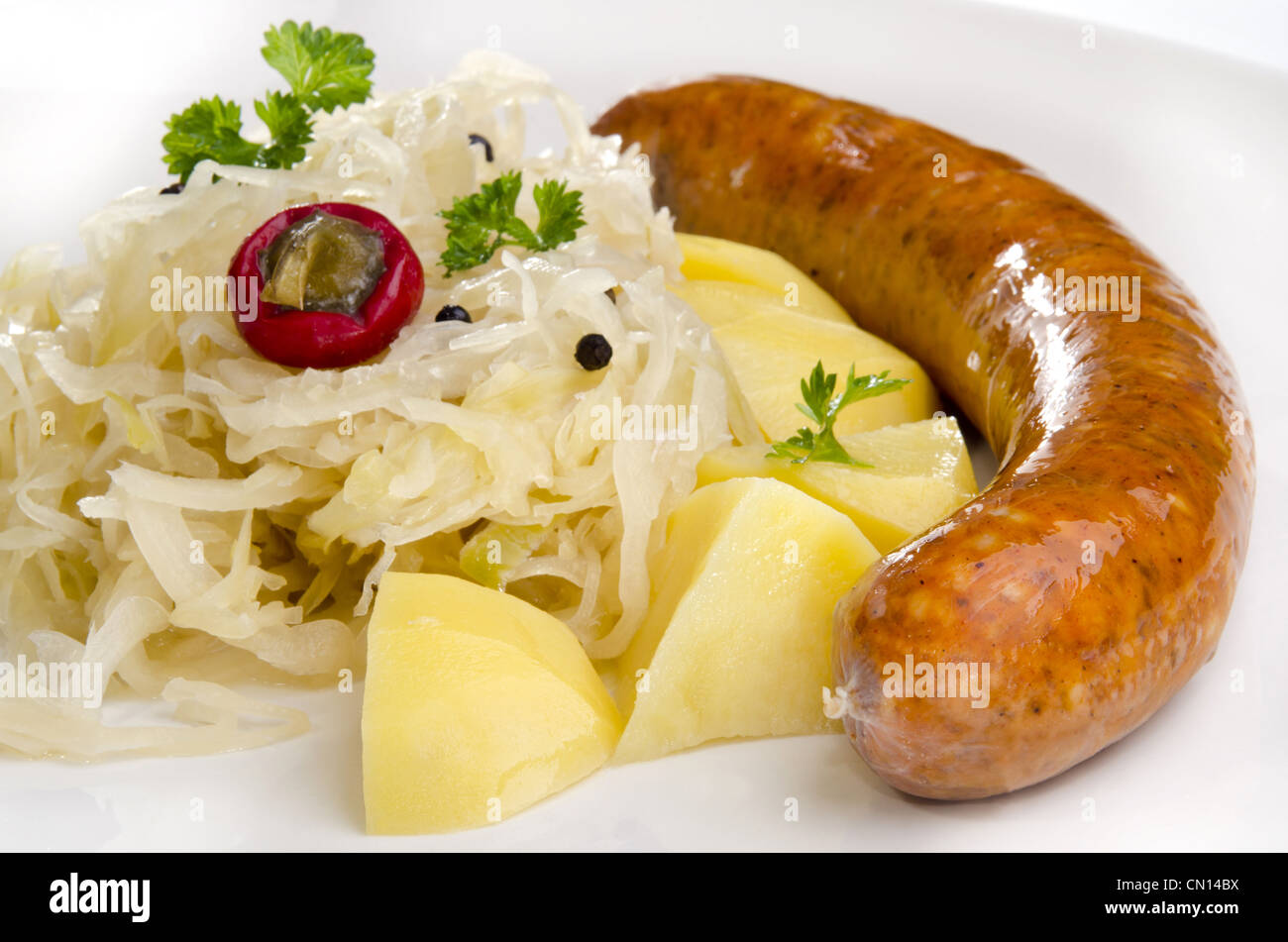 Sauerkraut with noodle and home made sausage on a white plate Stock Photo