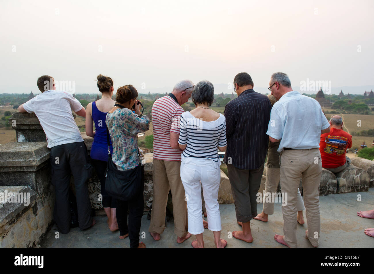 Tourists taking photos from the Shwe San Daw pagoda at sunset in Bagan, Myanmar Stock Photo