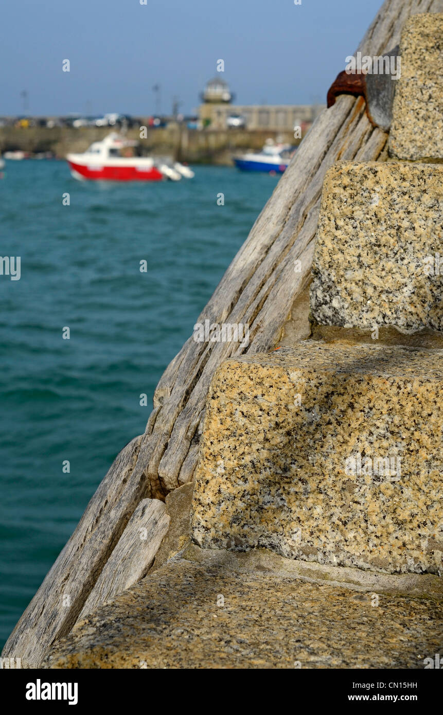 Harbour wall steps with view of old lighthouse St. Ives Cornwall UK Stock Photo