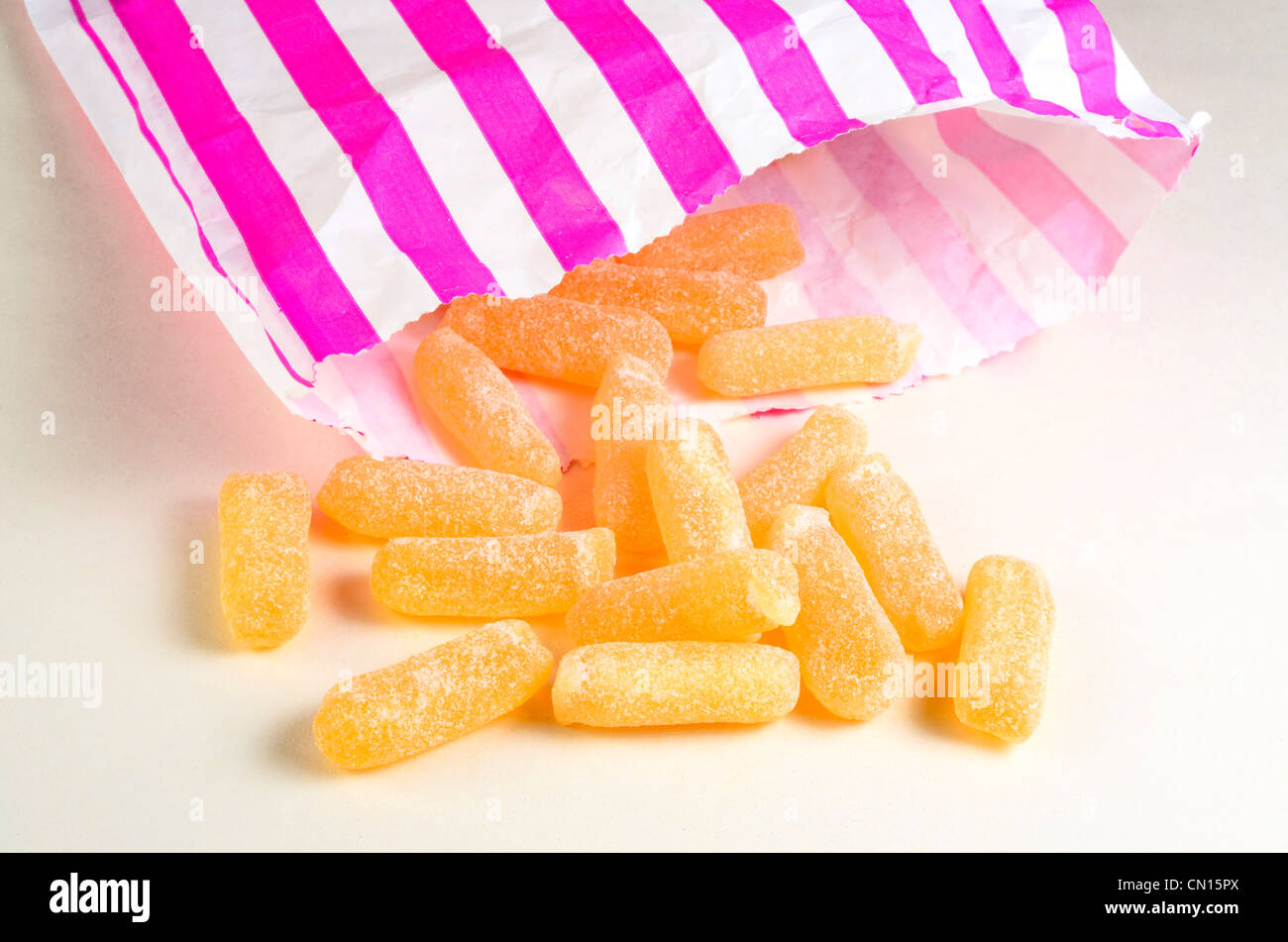 Cough candy with pink striped paper bag Stock Photo