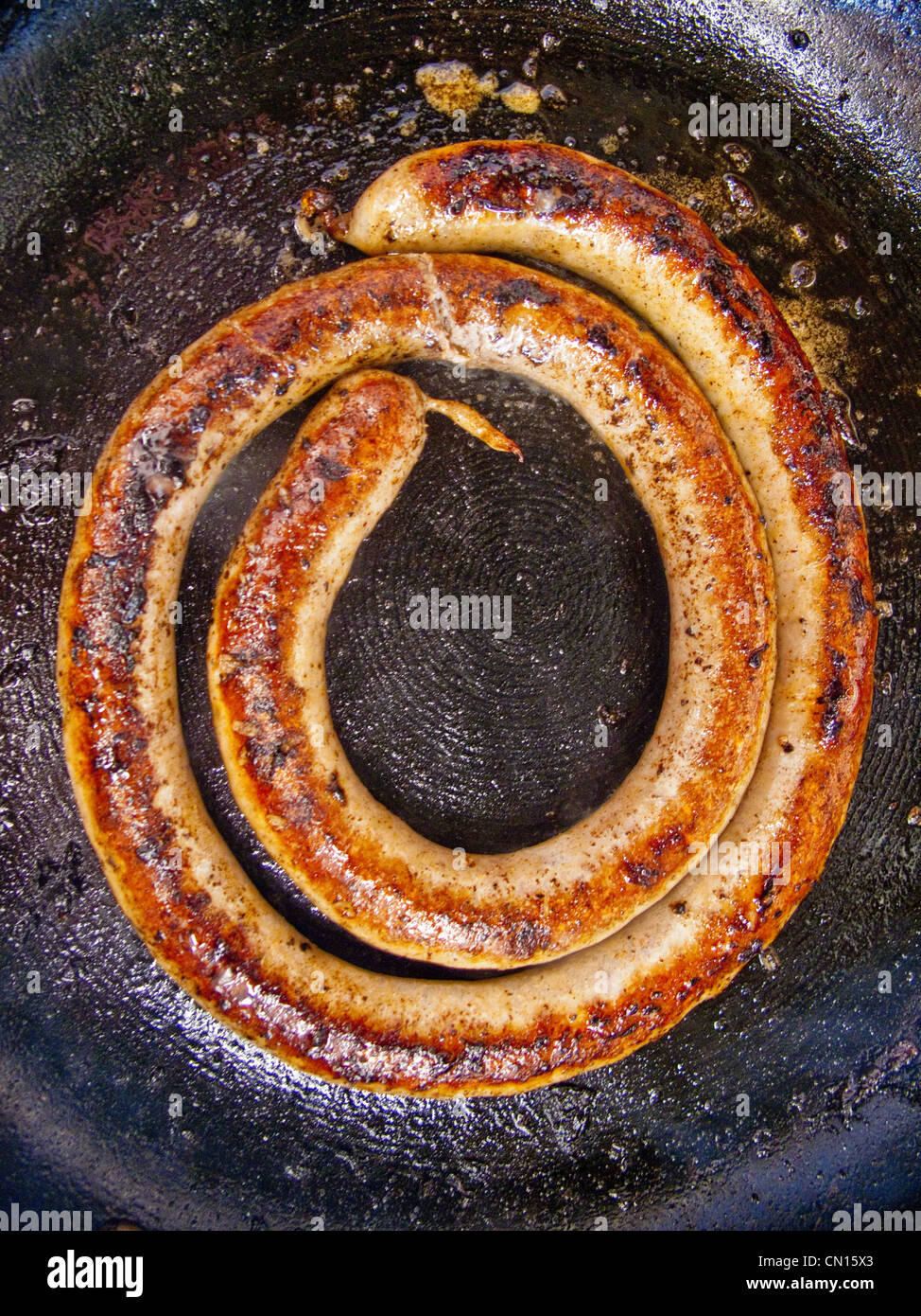 African sausage cooking in a fry pan. Stock Photo