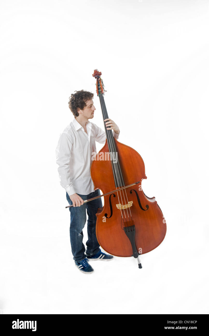 Double bassist with a bow next to his instrument Stock Photo