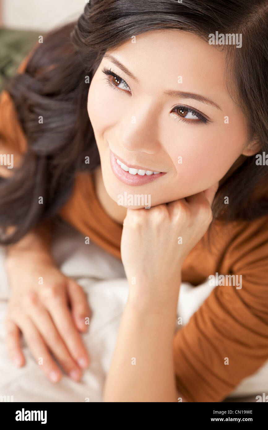 Portrait of a beautiful young Chinese Asian Oriental woman resting on her hand Stock Photo