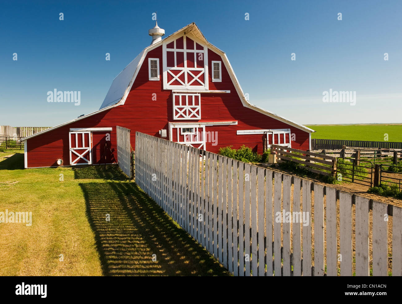 Red barn with fence, near Lake Alma, Saskatchewan Stock Photo