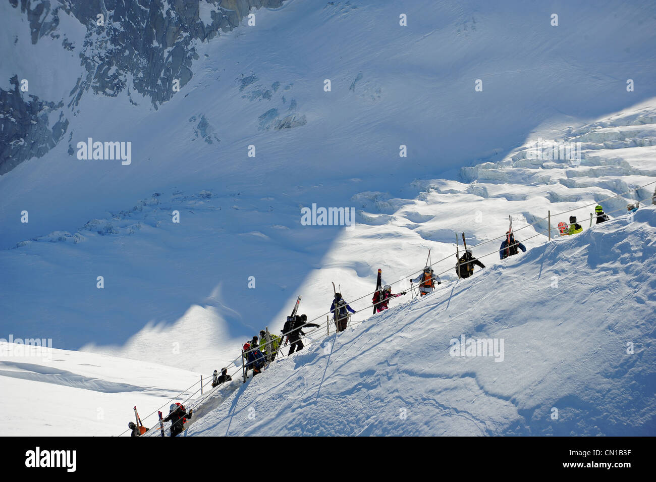 Skiers hike from the summit of Aiguille du Midi to the top of la Vallée Blanche in Chamonix, France. Stock Photo