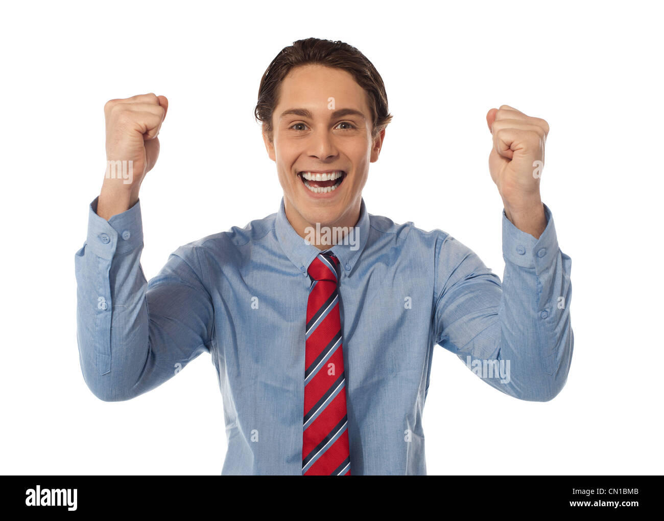 Confident Rising Up Portrait of confident young businessman celebrating success with arms ...