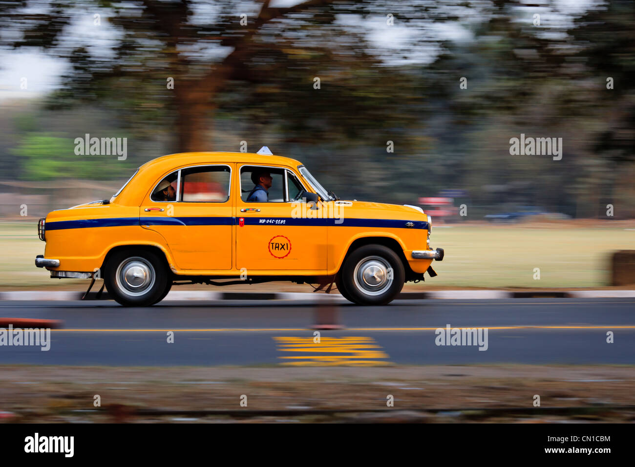 Indian Ambassador taxi speeding on a road in Kolkata, India Stock Photo