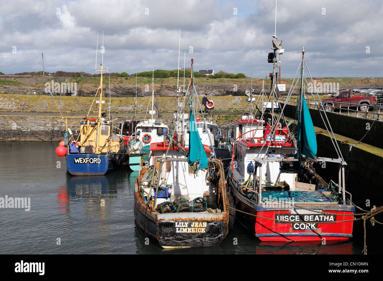 slade harbour harbor hook head wexford ireland fishing boats moor moored mooring stone wall pier Stock Photo