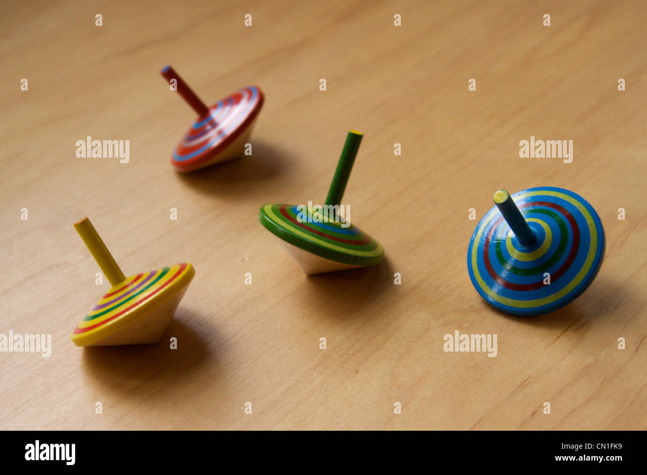 Four Colorful Toy Tops Stock Photo Alamy