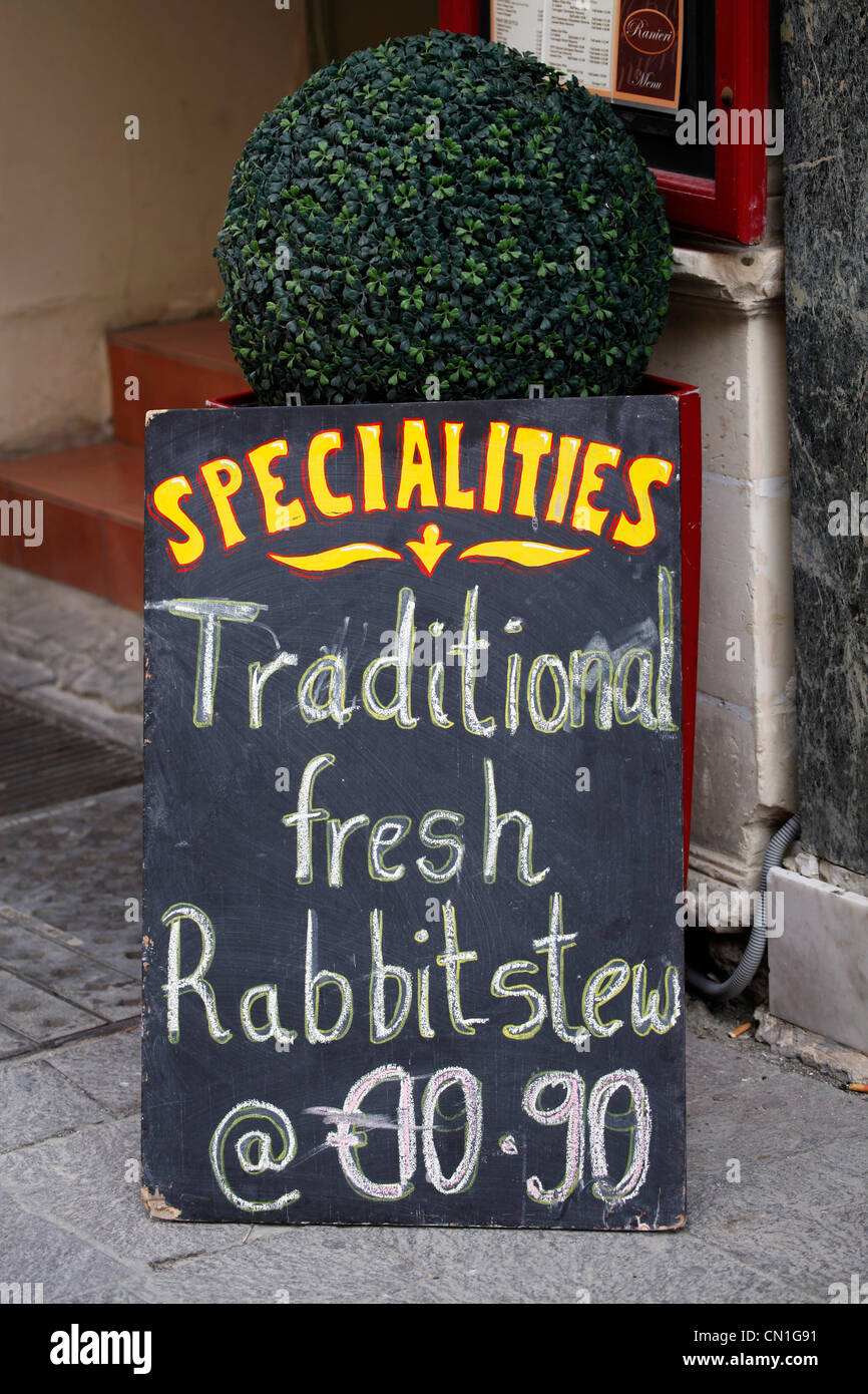 Traditional fresh rabbit stew on Maltese specialities menu board in Valletta, Malta Stock Photo