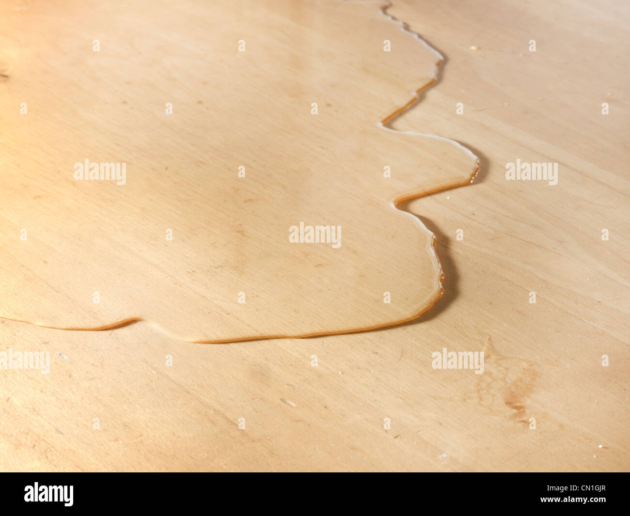 Small Pool of Water On A Work Surface Stock Photo