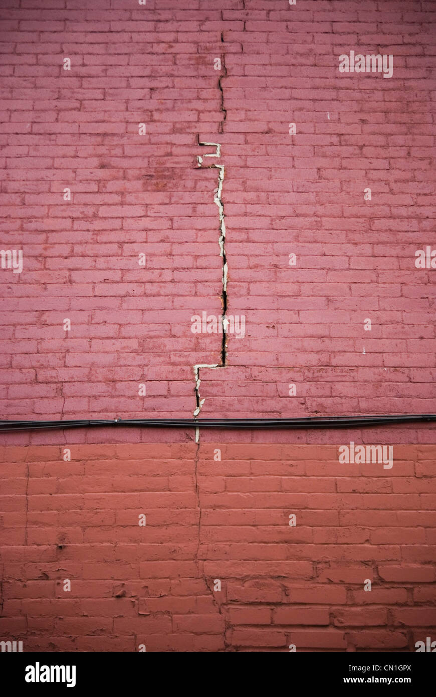 Crack in Red Brick Wall Stock Photo