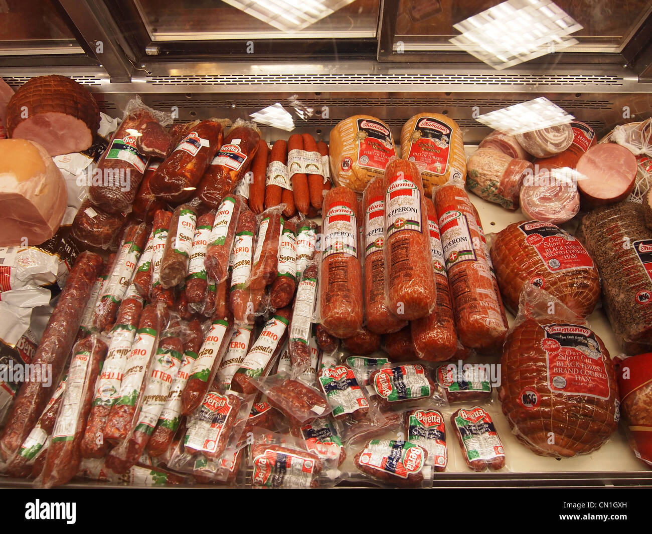 Various Italian cured meats and sausages on display in a delicatessen in New Jersey, USA, April 14, 2011, © Katharine Andriotis Stock Photo