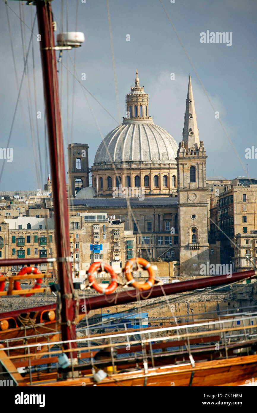 The spire of St. Paul's Anglican Pro-Cathedral and the Carmelite Church dome on the city skyline of Valletta, Malta Stock Photo