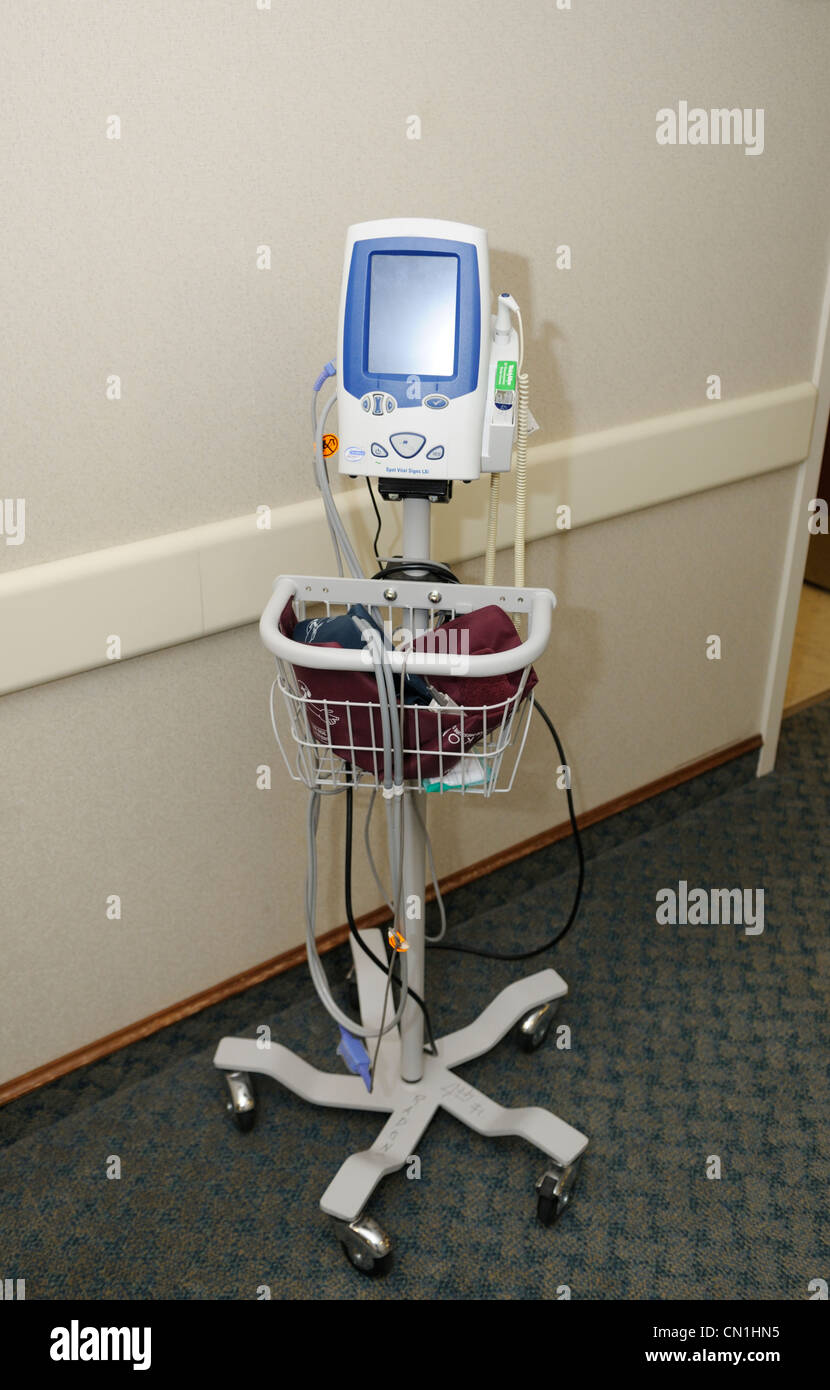 Mobile blood pressure unit in a doctor's suite corridor Stock Photo