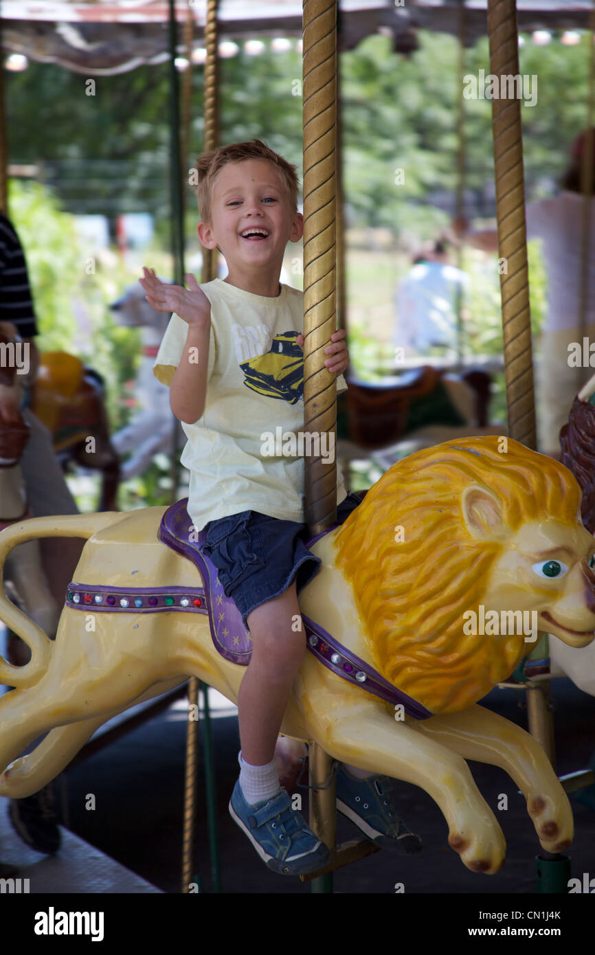 Smiling Boy on Carousel Stock Photo
