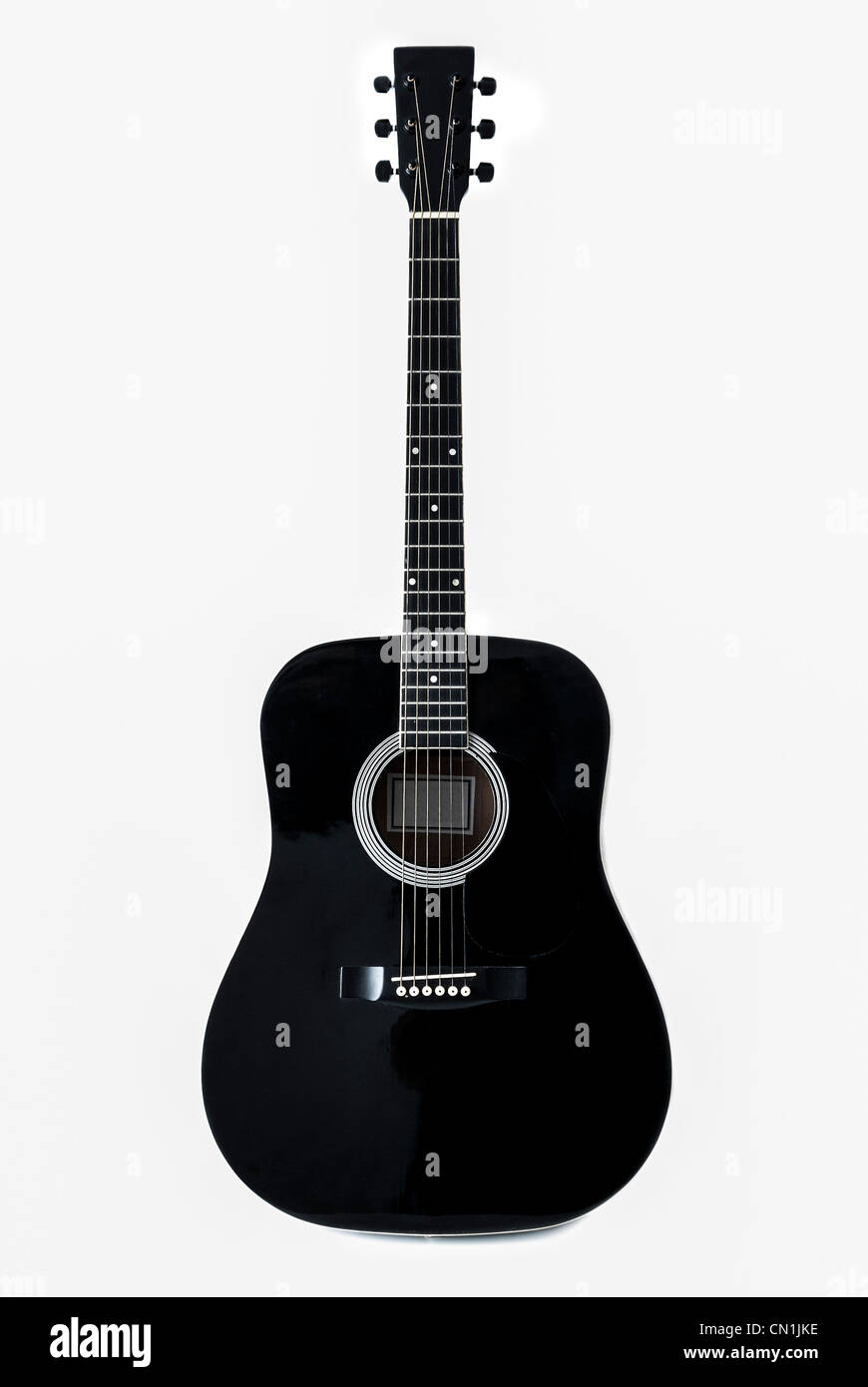 A black accoustic guitar isolated on a white background Stock Photo - Alamy