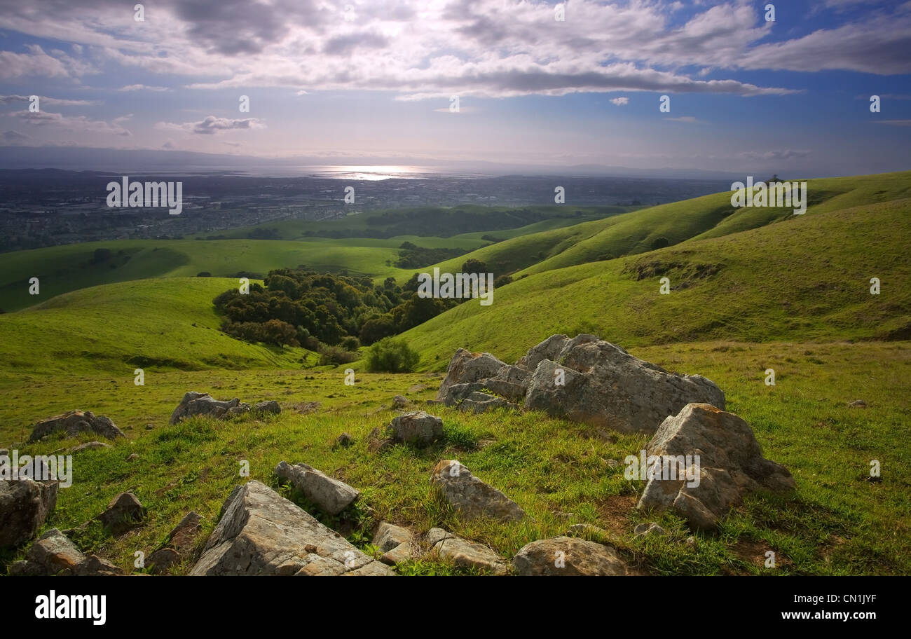 A photo a lush meadow and the East Bay Area of California from the foothills of the Diablo range, on a green, sunny spring day Stock Photo