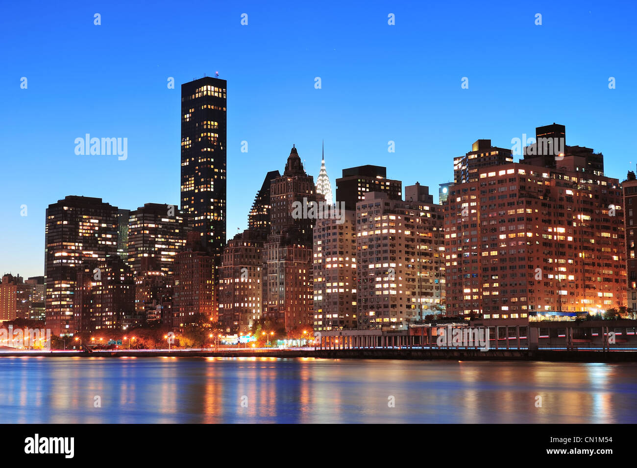 New York City Manhattan midtown skyline at night over East River Stock ...