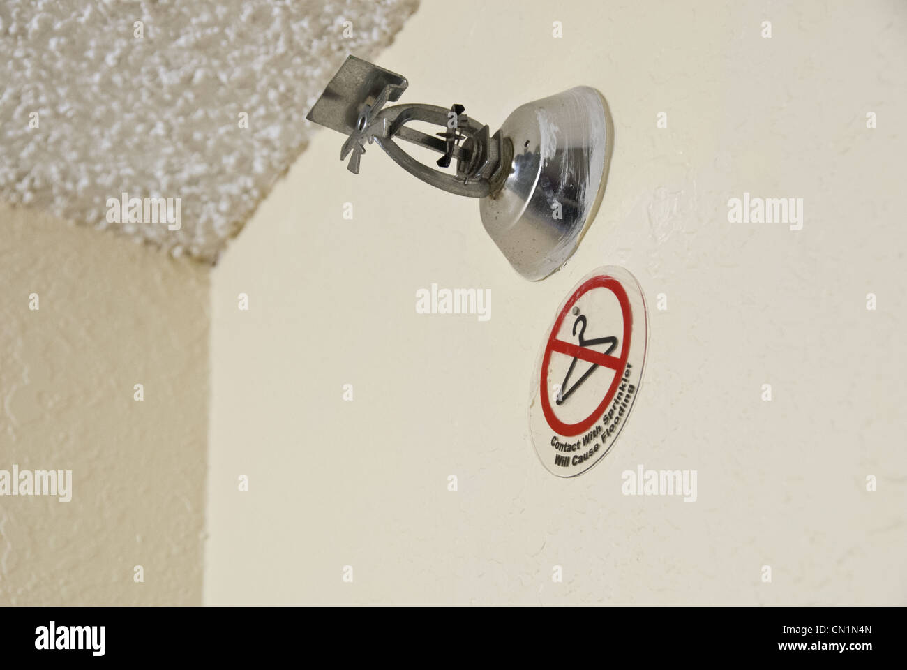 Fire prevention sprinkler and 'no clothes hangers' sign in hotel room, USA Stock Photo