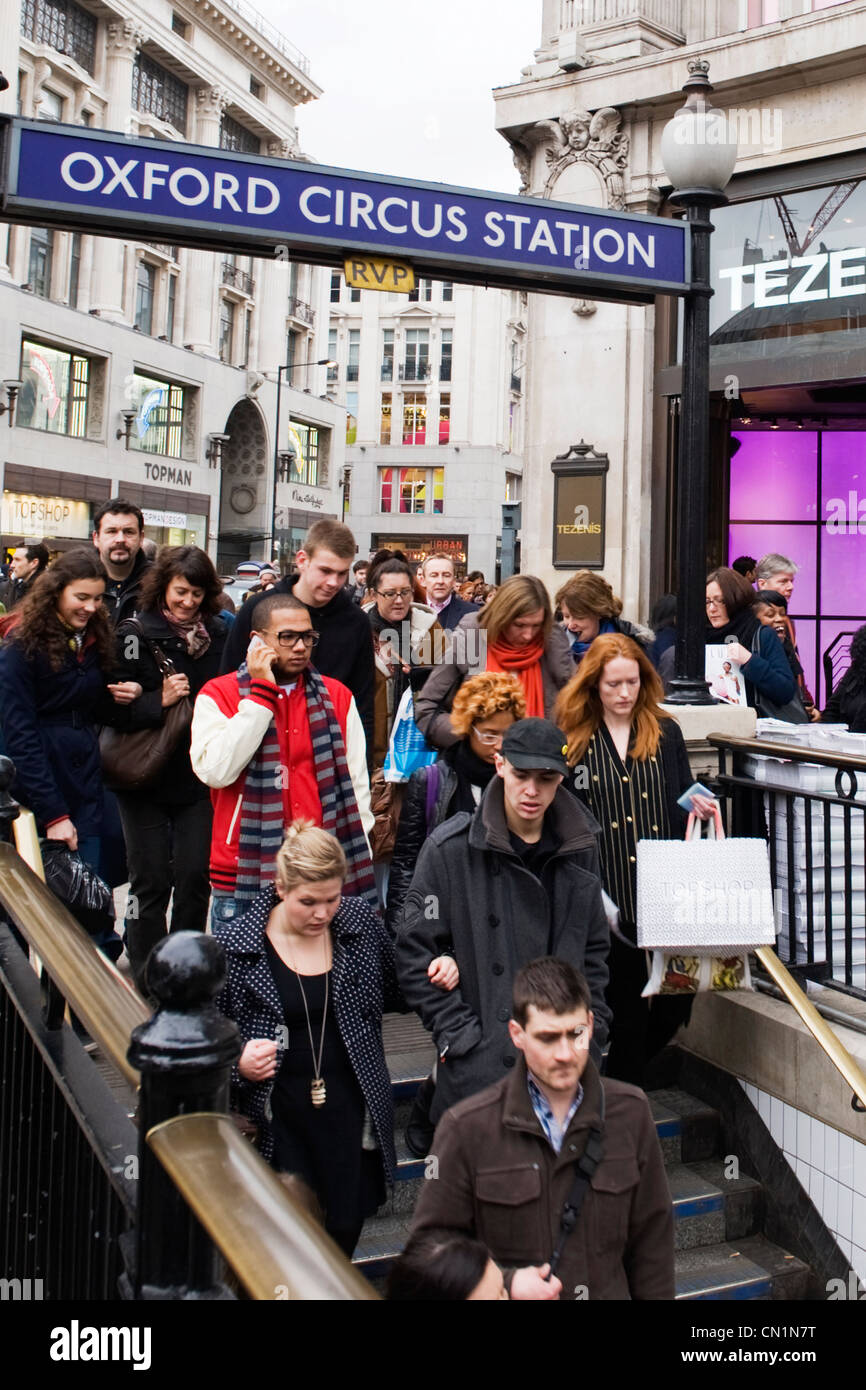London West End Oxford Circus underground tube entrance with crowds of people going down stairs to station shops stores Topshop Stock Photo
