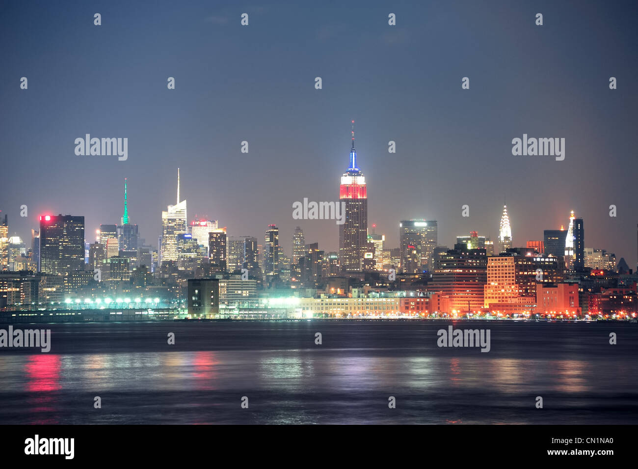 New York City Manhattan skyline at night with skyscrapers illuminated ...