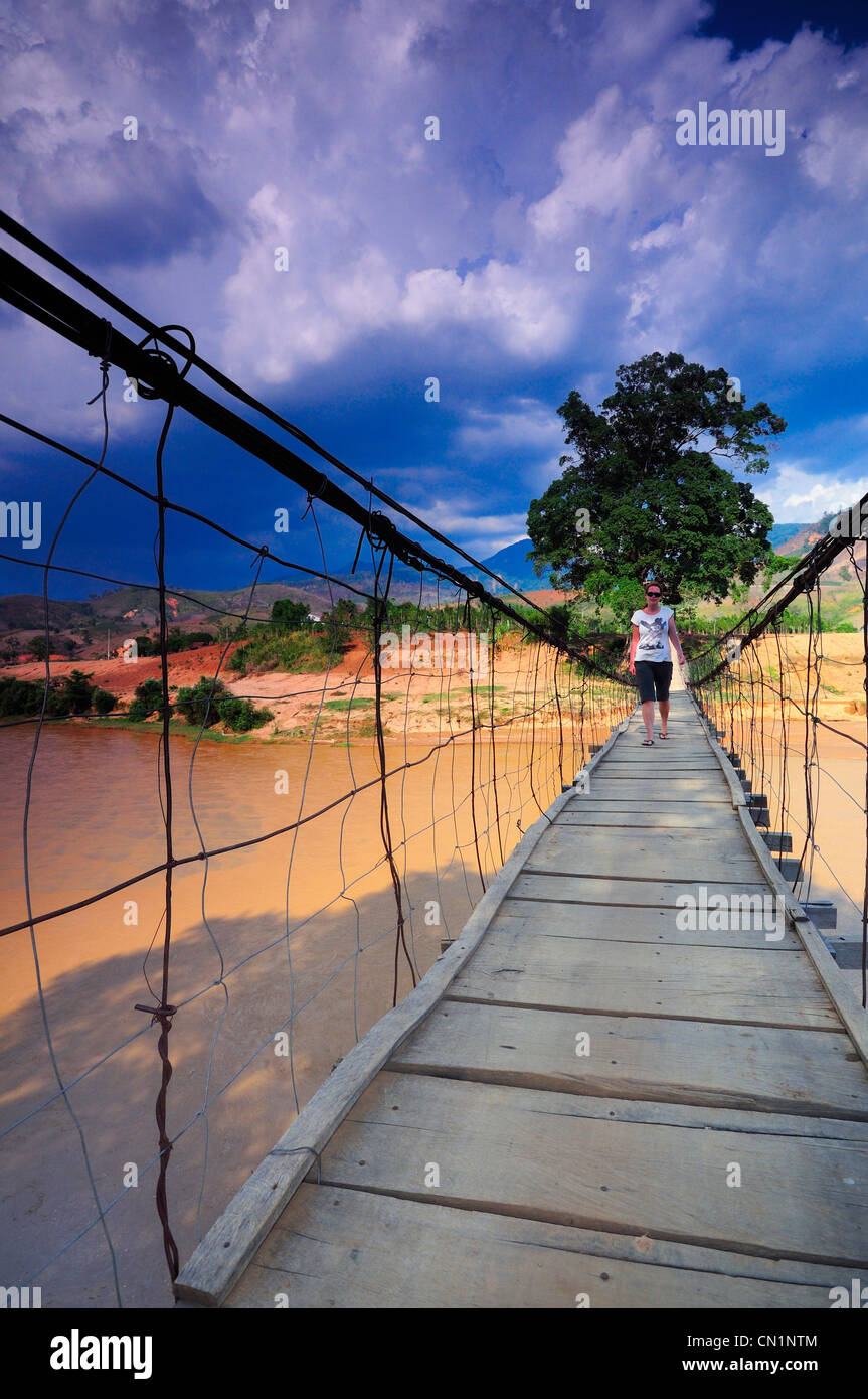 Woman Crossing Rope Woman crossing rope bridge hi-res stock photography and images - Alamy