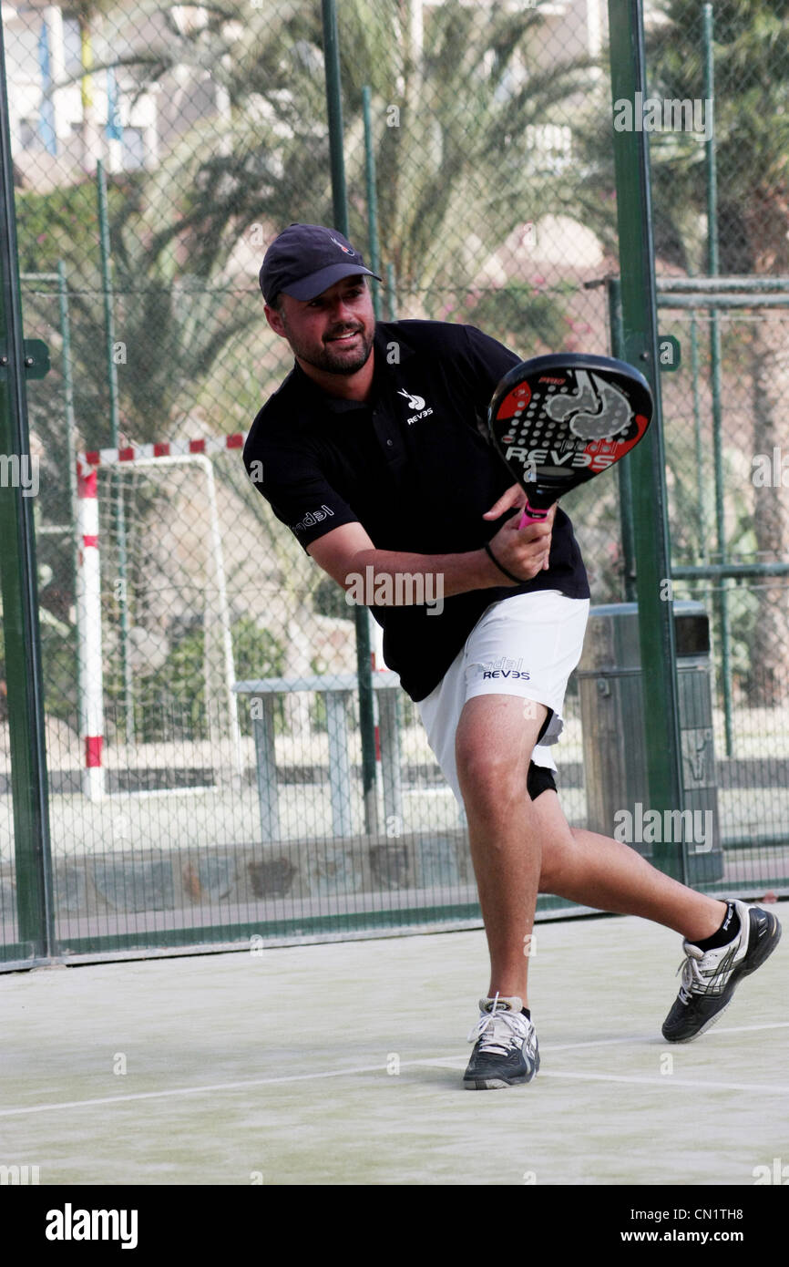 Young man playing padel tennis Stock Photo