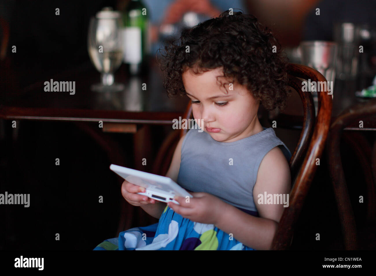 Girl Child Playing a Gameboy Stock Photo
