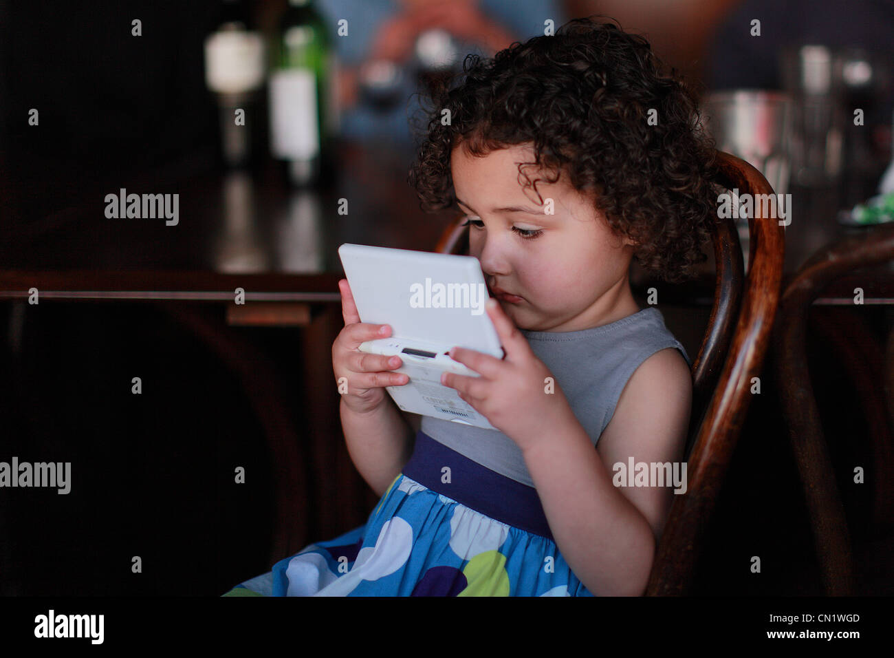 Girl Child Playing a Gameboy Stock Photo