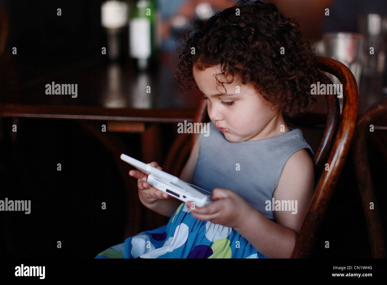 Girl Child Playing a Gameboy Stock Photo