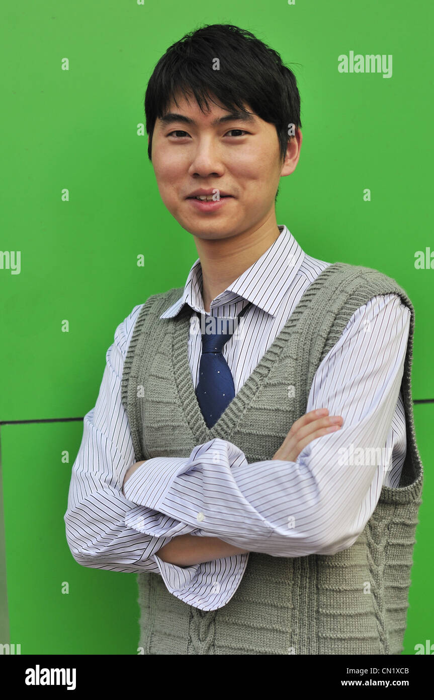 asian businessman leaning against the wall Stock Photo Alamy