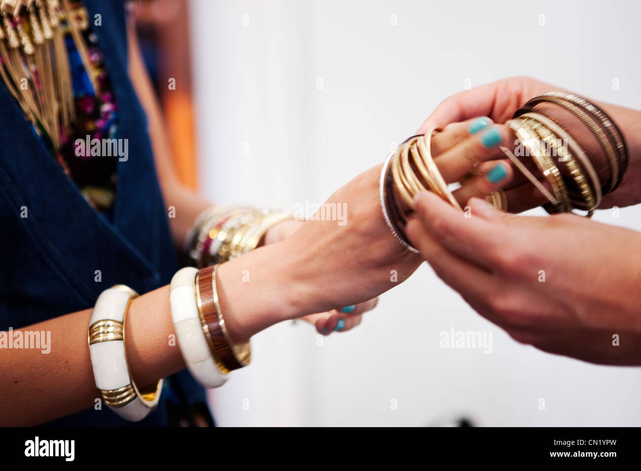 Braclets being put on for a fashion show Stock Photo