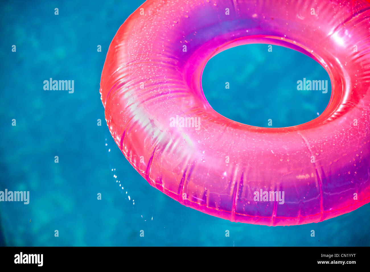 Pool Inflatable Insulator Thing Floating inflatable toys on pool in summer lit by warm sun Stock Photo ...