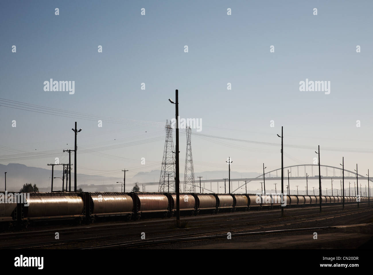 Train tankers and electricity pylons, Canada Stock Photo