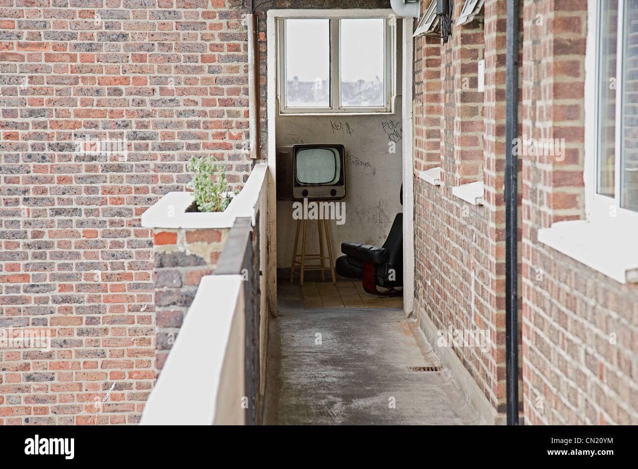 Retro television and armchair seen from apartment balcony Stock Photo