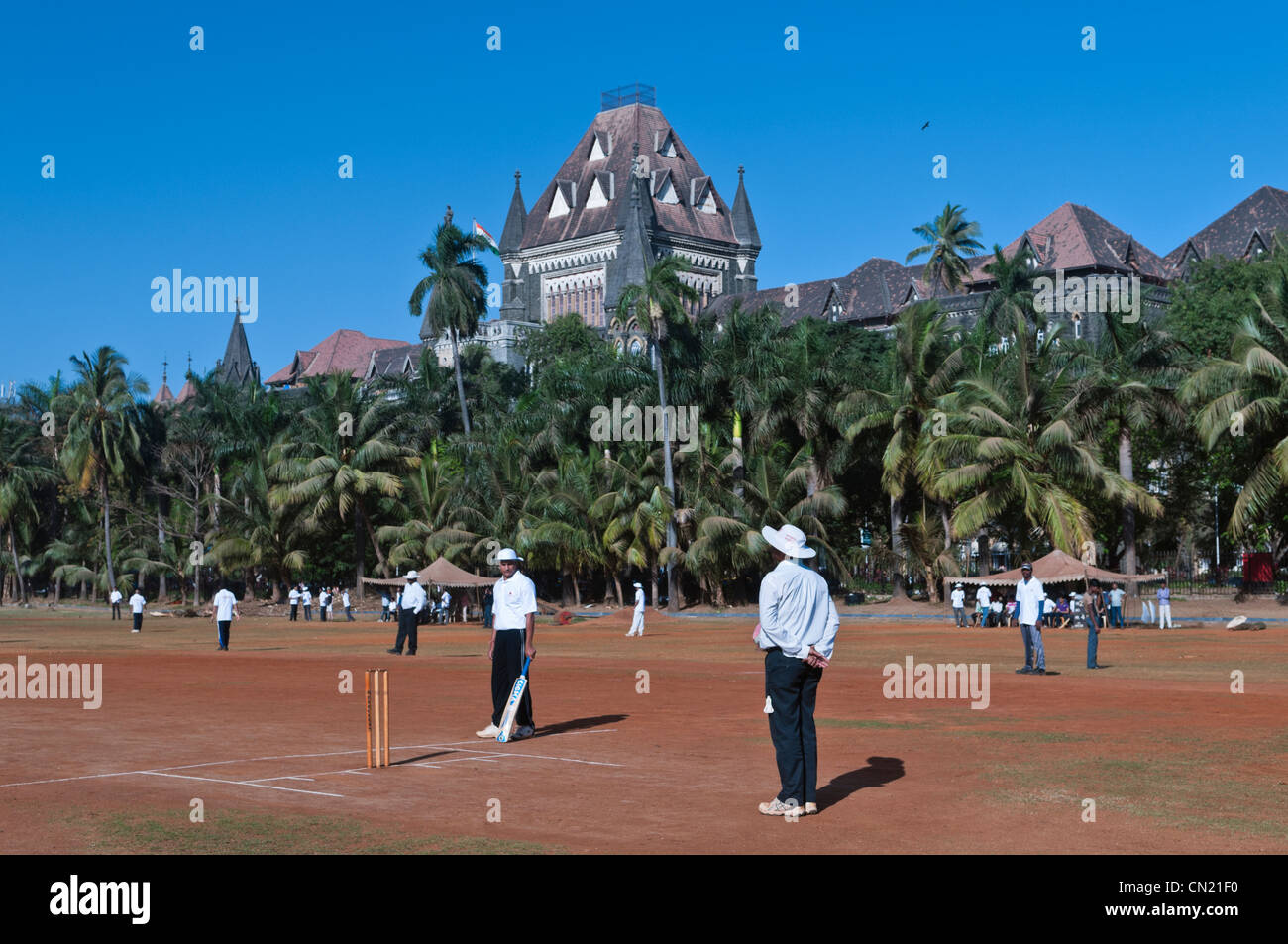 Playing cricket Oval Maidan High Court building Mumbai Bombay India Stock Photo
