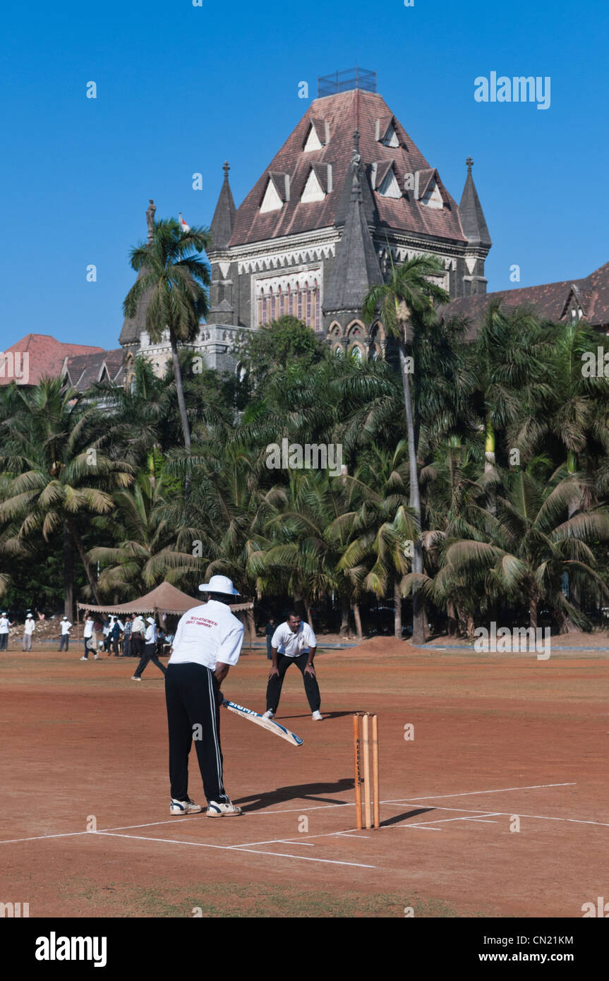 Playing cricket Oval Maidan High Court building Mumbai Bombay India Stock Photo