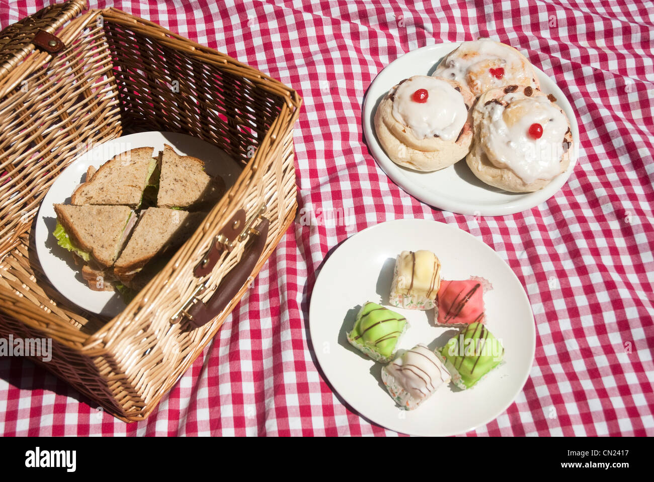 Picnic hamper with sandwiches and cakes Stock Photo