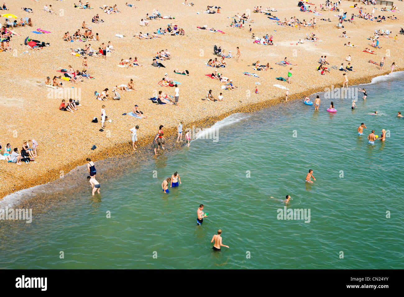 People on crowded beach, Brighton, England Stock Photo