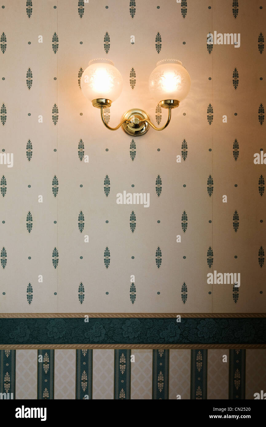 Wall lamp against patterned wallpaper Stock Photo
