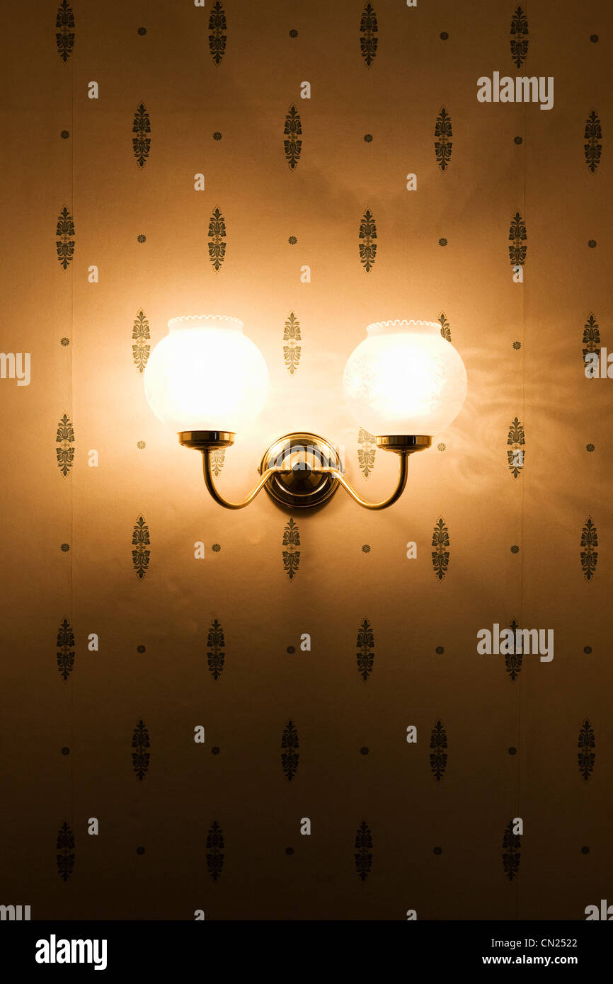 Wall lamp against patterned wallpaper Stock Photo