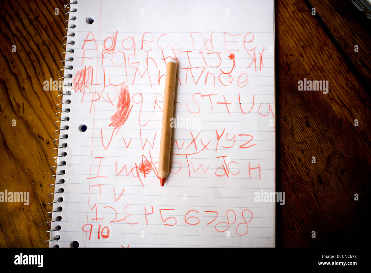 Child's writing on notepad with pencil Stock Photo