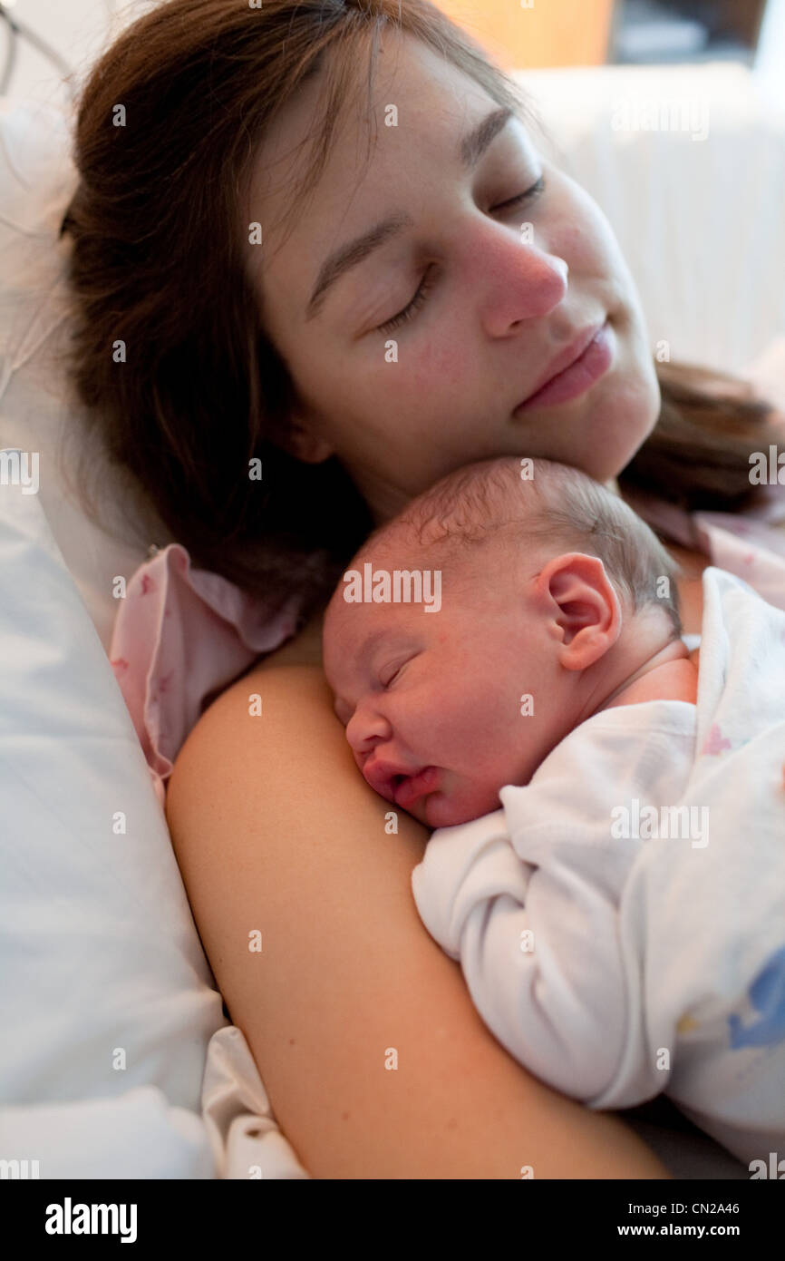 Mother and newborn baby boy sleeping in hospital bed Stock Photo Alamy