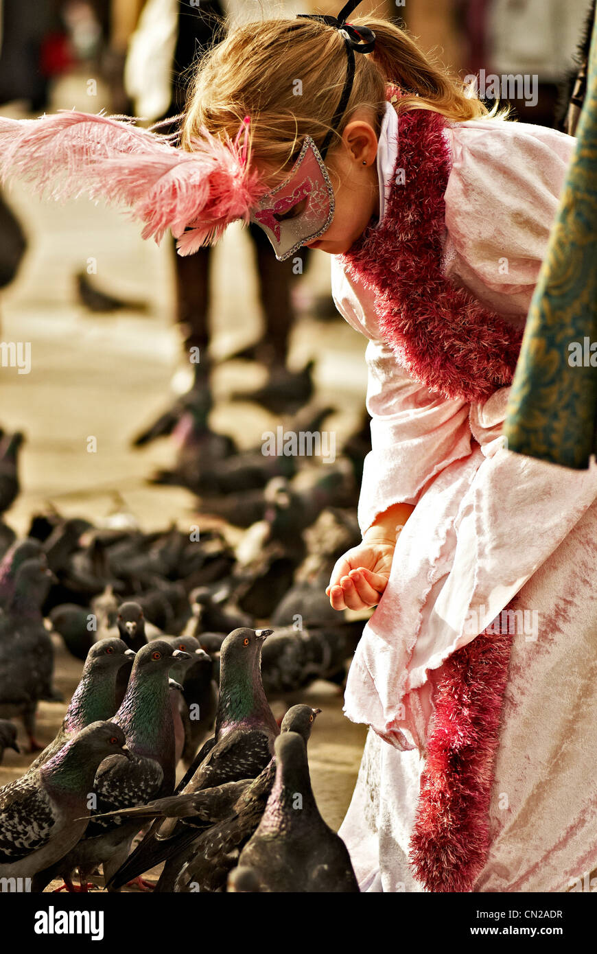 Masked people feeding pigeons during The Venice Carnival Stock Photo Alamy