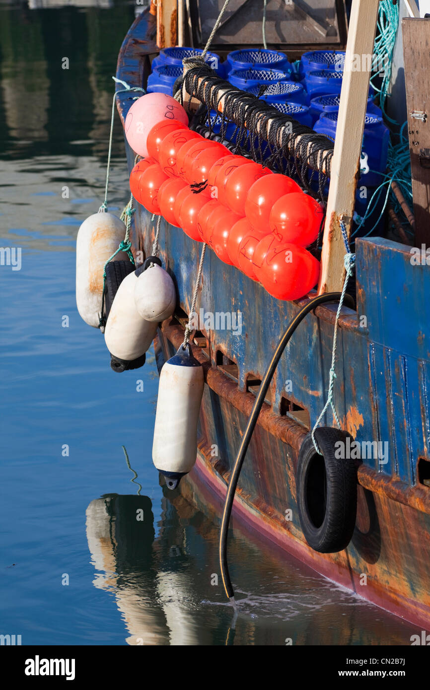 Fenders on fishing boat, UK Stock Photo