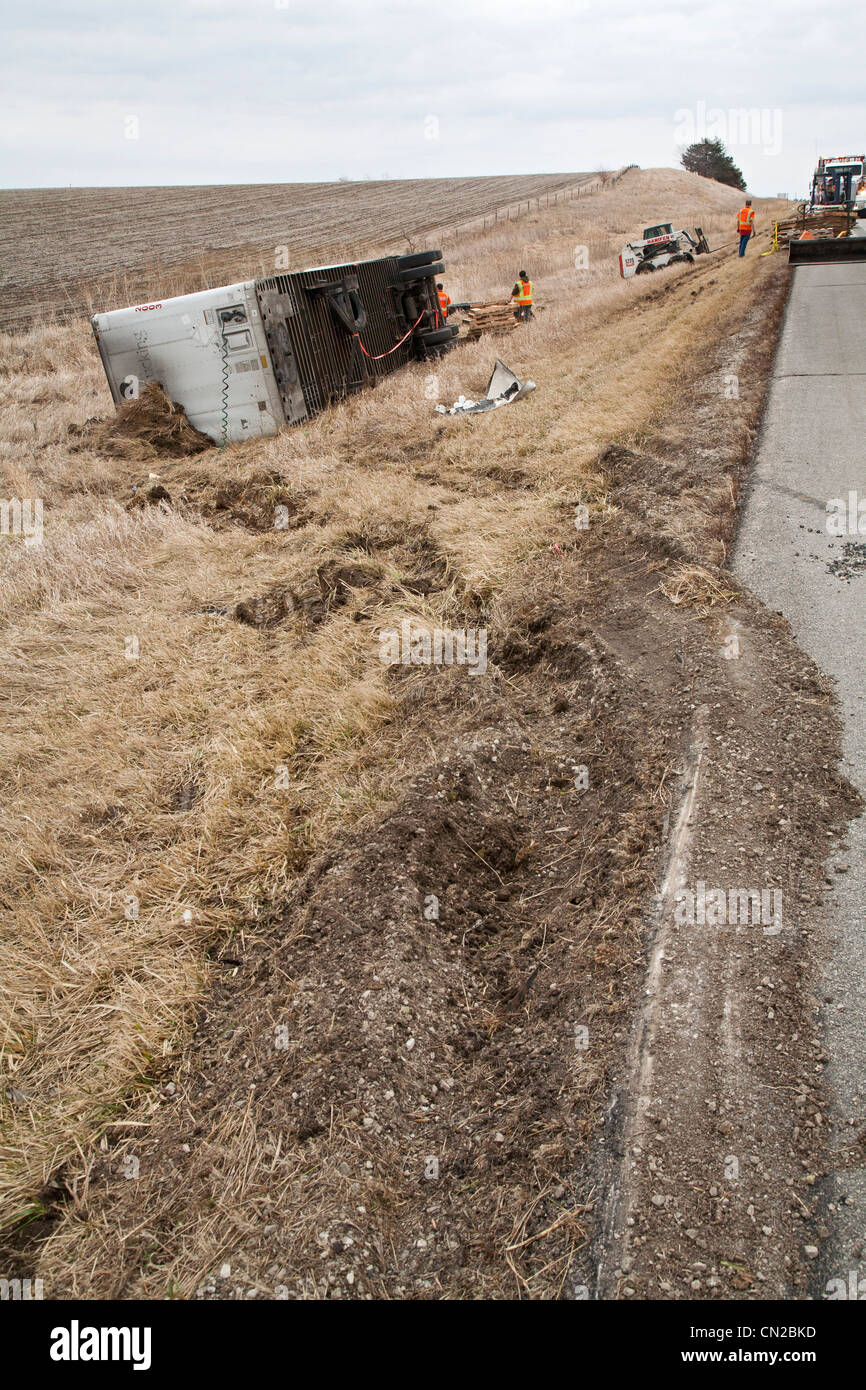Malcolm, Iowa Salvage workers clean up a truck wreck along Interstate