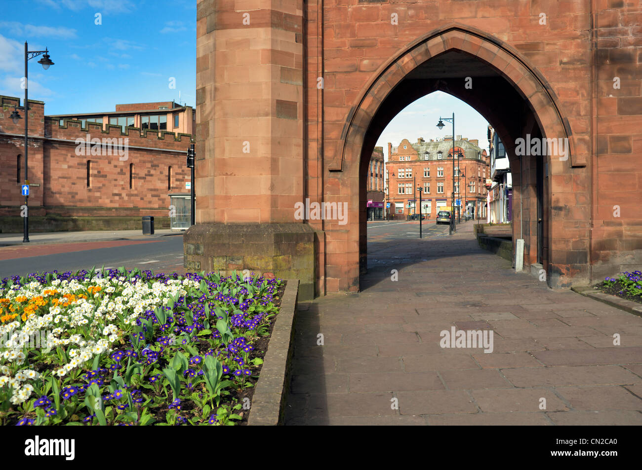 Carlisle City center looking through one of the arches of the Citadel towards the main shopping area, Cumbria, United Kingdom Stock Photo